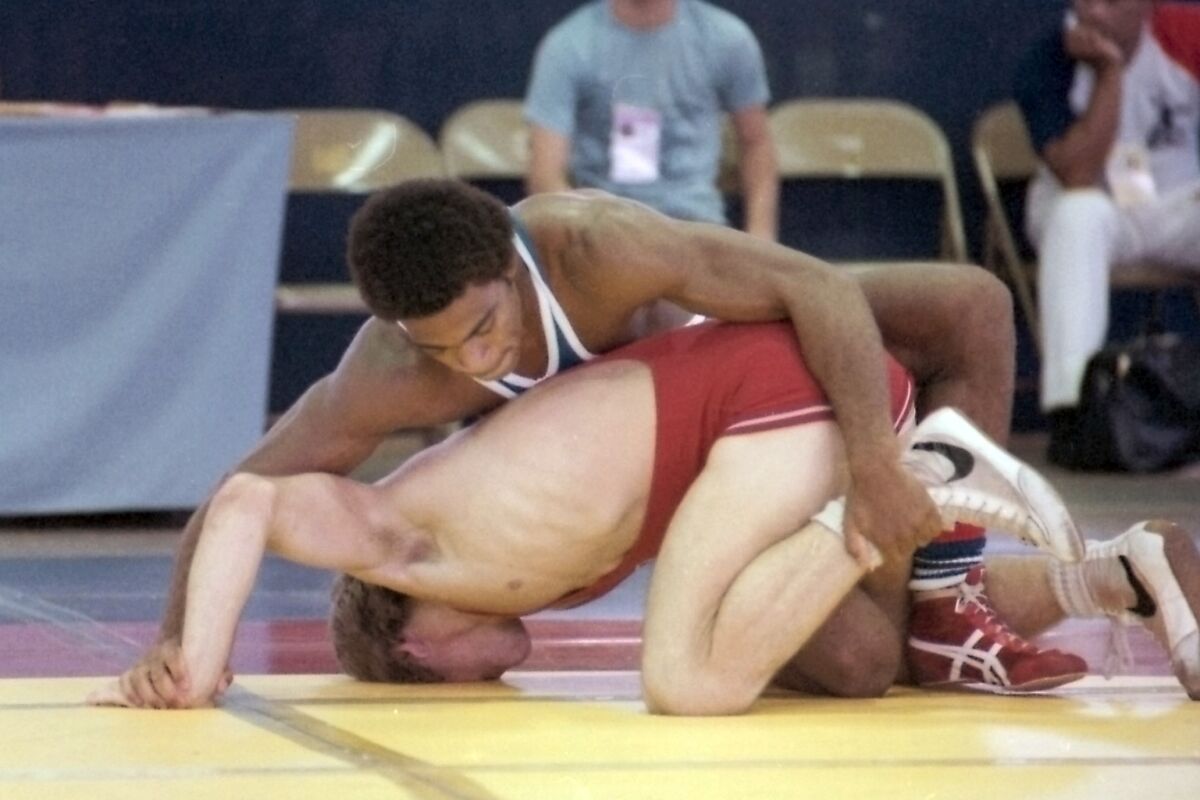 In this image provided by the U.S. Olympic and Paralympic Committee (USOPC), United States wrestler Lee Kemp, top, competes in the 1979 Pan American Games in San Juan, Puerto Rico. The U.S. boycott of the Moscow Olympics crushed Kemp's dreams, along with all the predictions that he would win a gold medal. (Walter Meives/USOPC via AP)