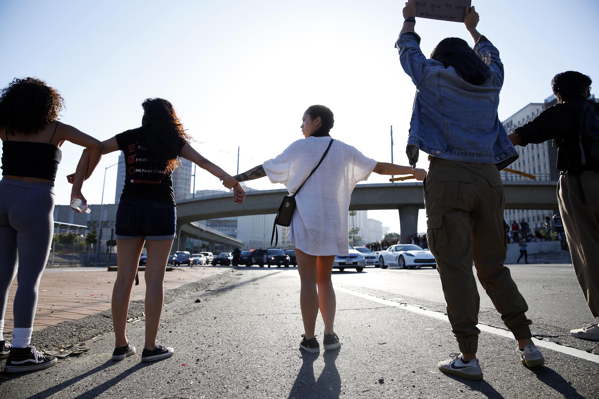 Protesters link hands across the 101 Freeway in downtown Los Angeles in a demonstration over the death of George Floyd in Minneapolis.