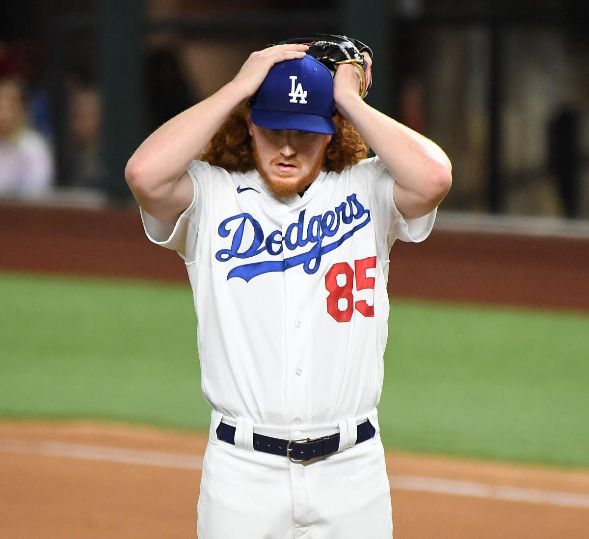 Dodgers pitcher Dustin May holds his head after giving up a two-run double to the Rays in the fourth inning.