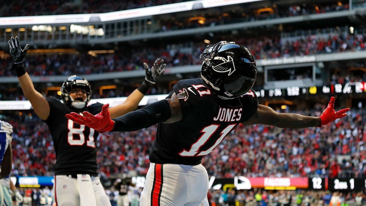 Atlanta Falcons' Julio Jones (11) celebrates after pulling in a touchdown reception against the Dallas Cowboys at Mercedes-Benz Stadium on Nov. 18, 2018, in Atlanta.