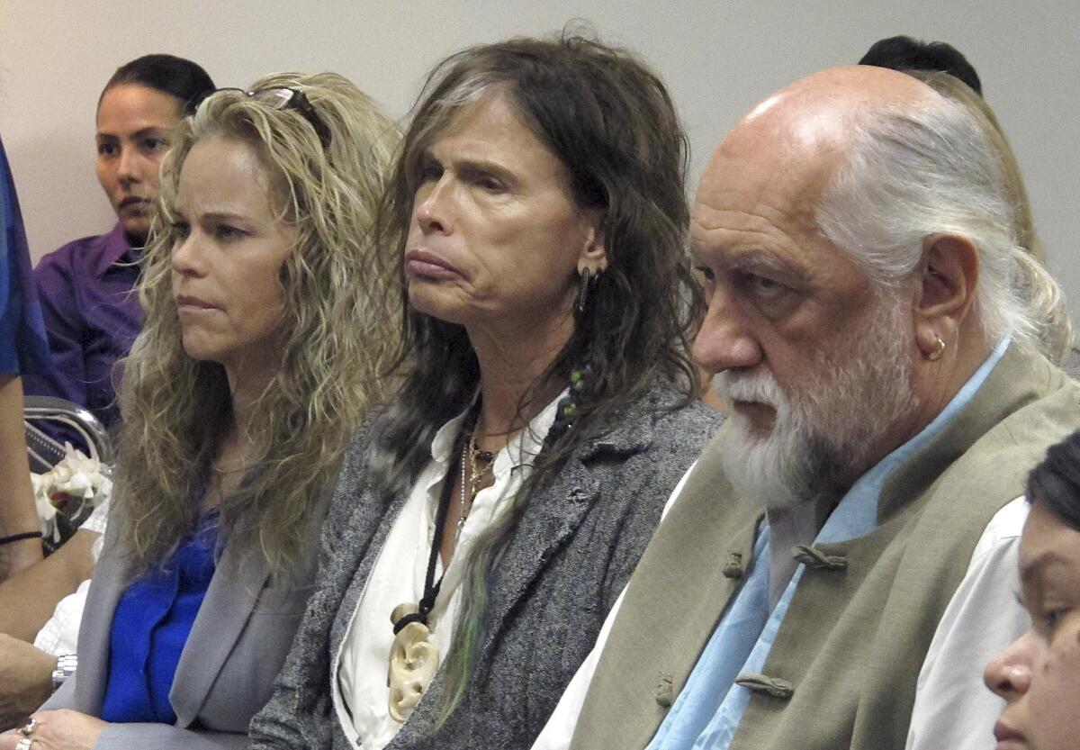 Aerosmith lead singer Steven Tyler, center, with his attorney Dina LaPolt, left, and Fleetwood Mac drummer Mick Fleetwood as they listen to testimony on a celebrity privacy bill during a hearing at the Hawaii Capitol in Honolulu.