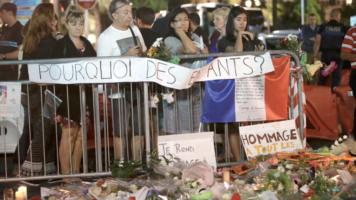 "Why the children?" asks a sign at a memorial to honor the attack victims on the Promenade des Anglais.