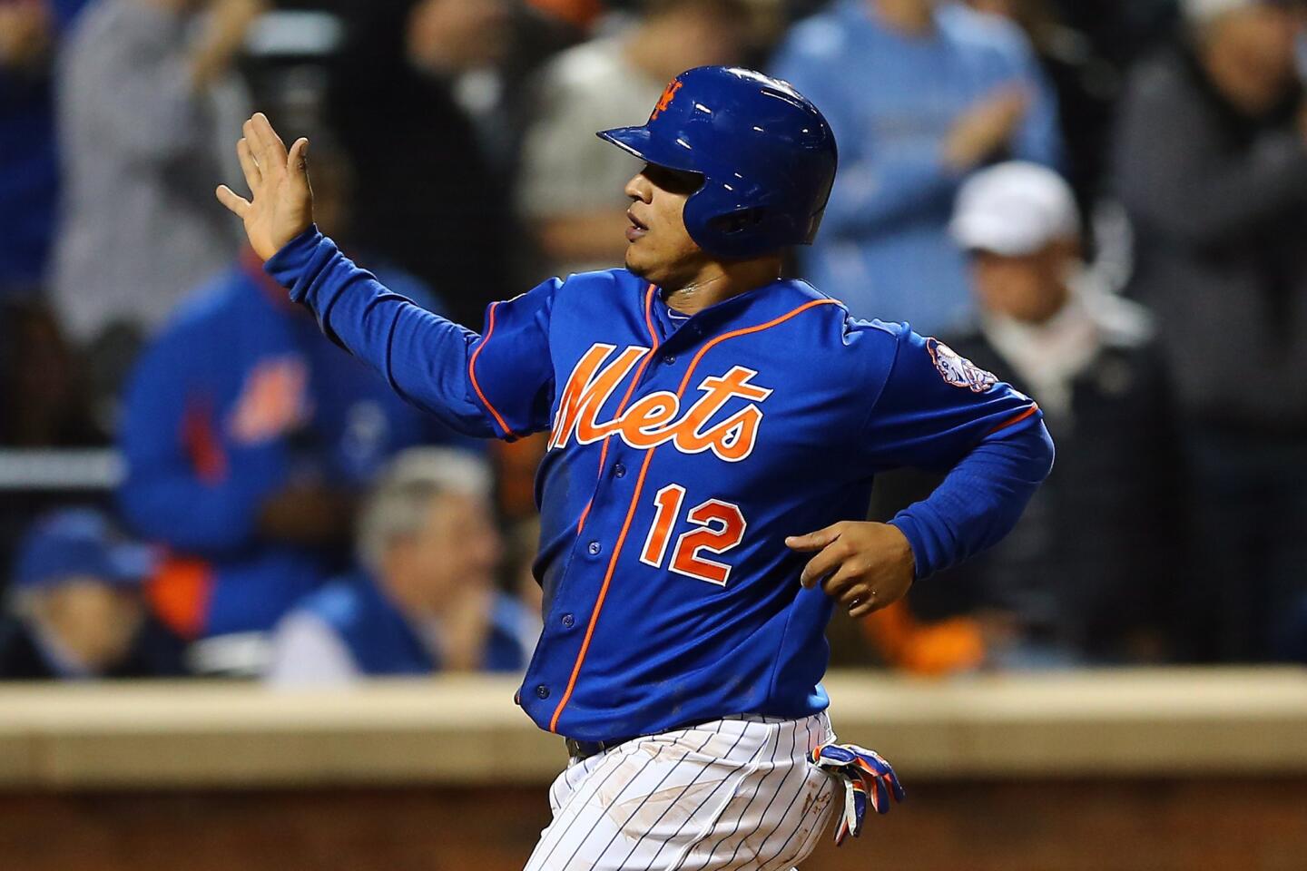 New York Mets center fielder Juan Lagares scores off of a Daniel Murphy single in the fourth inning of Game 3 of the National League division series.