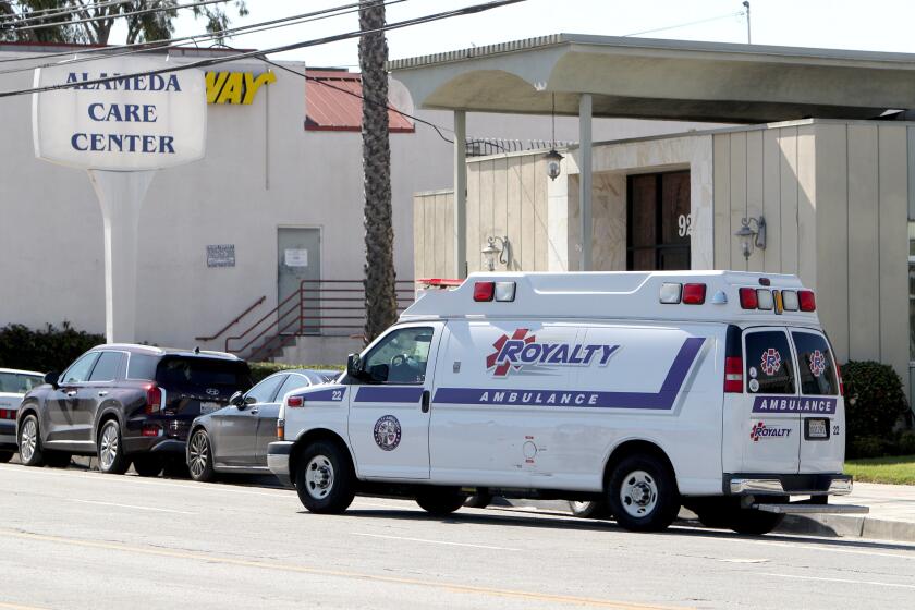 An ambulance drives away with a patient, whose condition is unknown, picked up from Alameda Care Center, on W. Alameda Ave., in Burbank on Friday, March 27, 2020. The center is reporting multiple positive cases of the novel coronavirus COVID-19 (SARS-CoV-2) by its senior residents. No deaths have been reported at the facility.