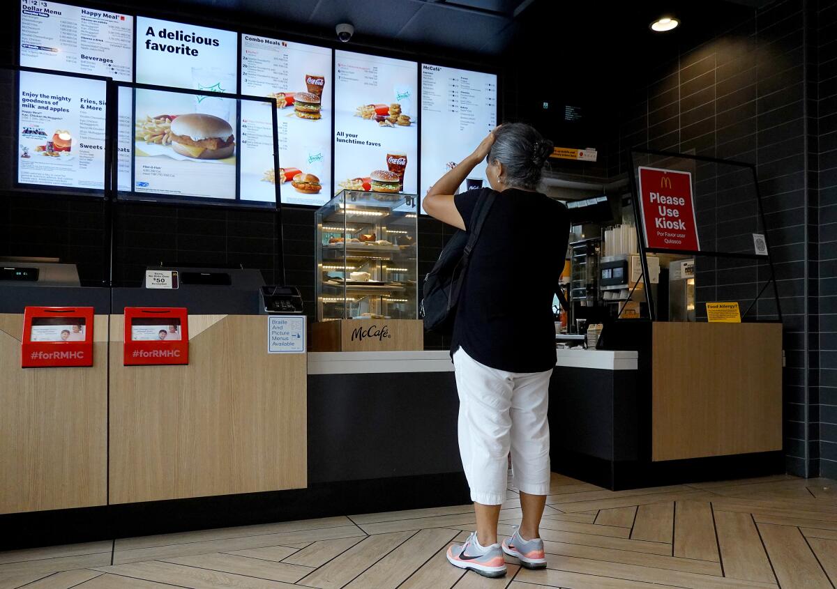 A customer waits to order food at a McDonald's in Miami.