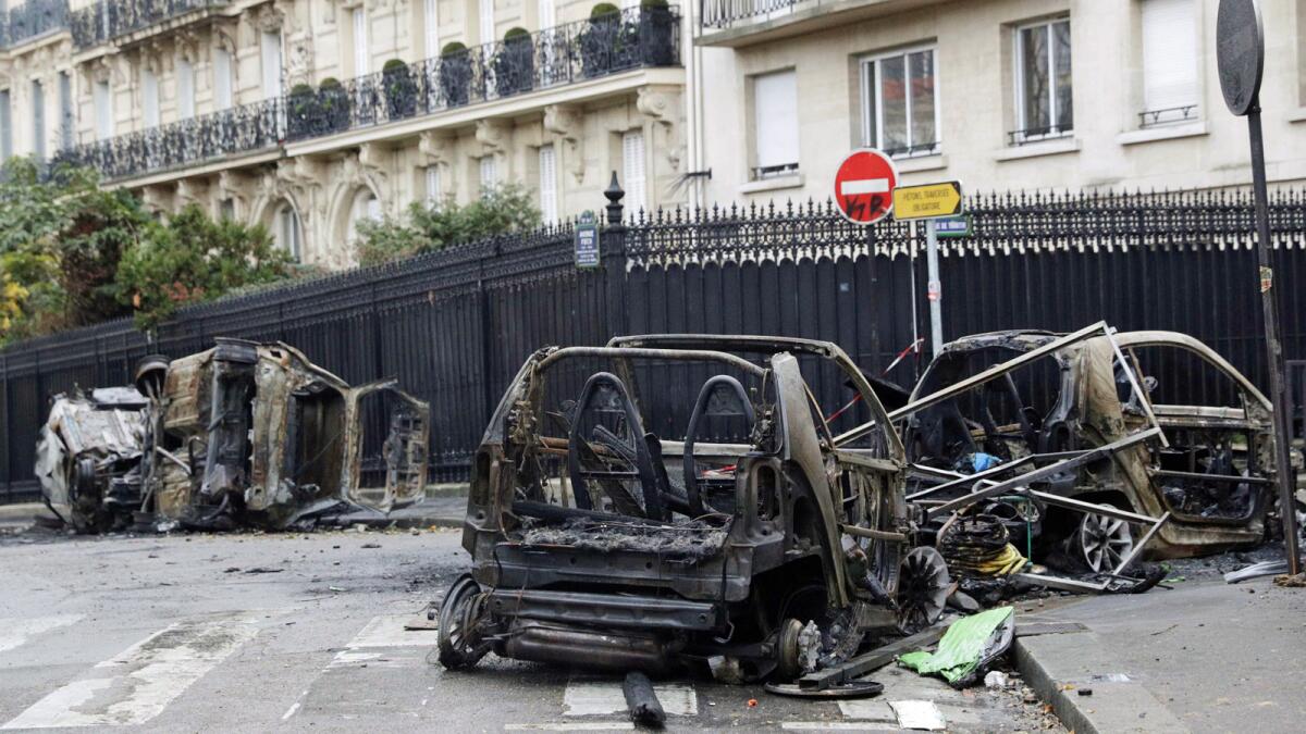 Burned cars on a Paris street a day after the protest.