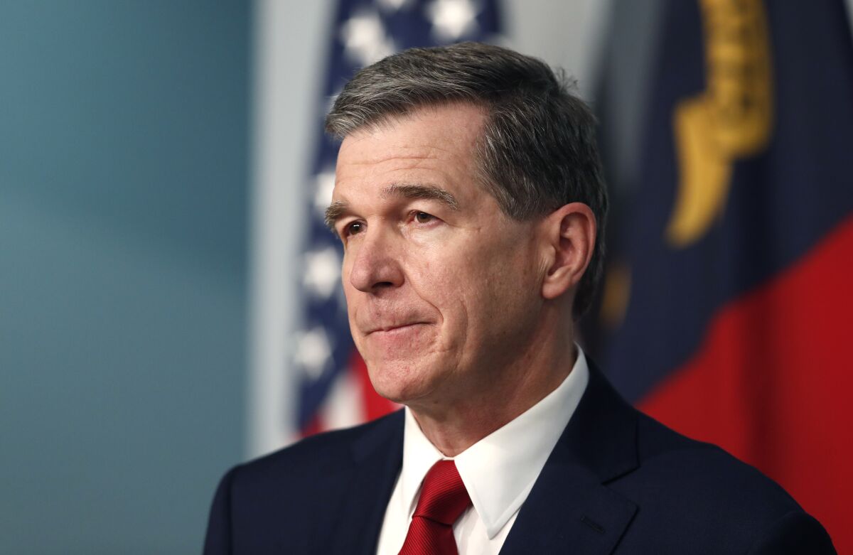 FILE - Gov. Roy Cooper listens to a question during a briefing at the Emergency Operations Center in Raleigh, N.C., Tuesday, July 14, 2020, amid the coronavirus pandemic. Cooper will discuss the pandemic, education and his re-election bid in an interview with The Associated Press on Thursday, Aug. 6. (Ethan Hyman/The News & Observer via AP, File)