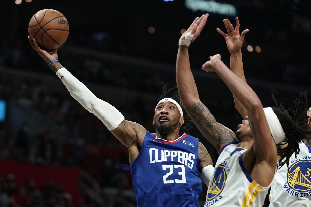 Clippers forward Robert Covington shoots as Golden State Warriors guard Damion Lee defends.