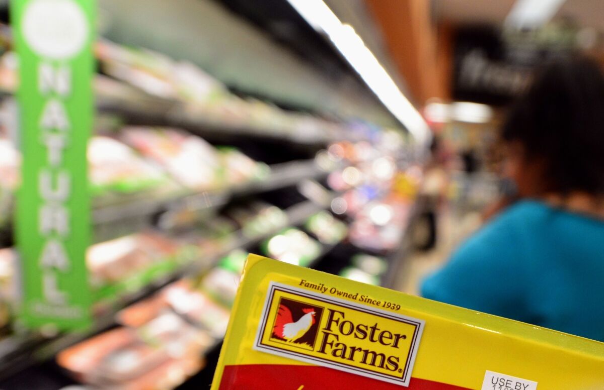 The label from a package of Foster Farms chicken is displayed as a woman shops in a Los Angeles supermarket on Oct. 8, 2013, in California.