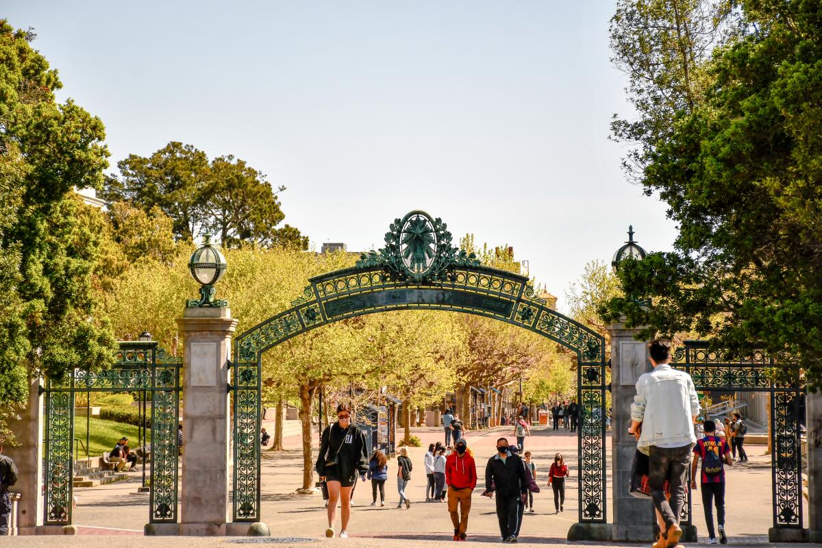 Students walk through a gate on the UC Berkeley campus.