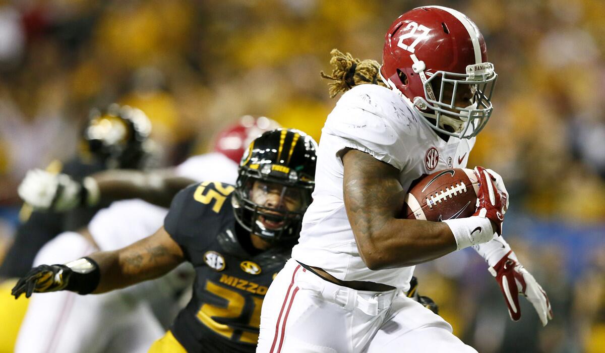Alabama running back Derrick Henry breaks past Missouri linebacker Donavin Newsom for one of his two touchdowns of the game Saturday in the SEC championship game.