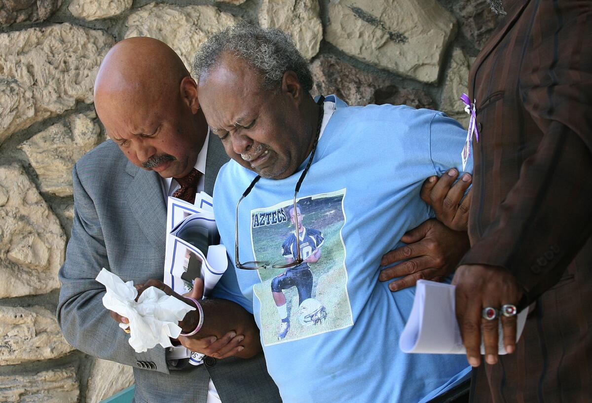 Alfred McDade, center, mourns at the funeral for his grandson Kendrec McDade at Metropolitan Baptist Church in Altadena on April 7, 2012.