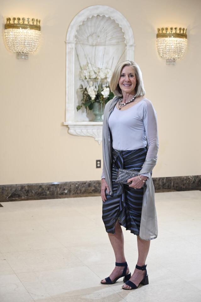 Who: Megan Kalkstein, 60, Harbor East resident; nutritionist Spotted at: The Great Chefs’ Dinner at The Grand Lodge of Maryland, benefiting The Family Tree What she wore: Blue-gray long sleeve top from Nordstrom; striped ruched pencil skirt with front ruffle from veronicabeard.com; Louise Et Cie black suede sandals with block heels from Poppy & Stella; gray chiffon wrap from Nordstrom; gray and silver beaded and sequined evening bag from Nordstrom Rack; multi-strand bead and pearl necklace from Amaryllis; and David Yurman bangle from Radcliffe Jewelers. Her “updated contemporary” style: “I buy a few quality pieces every season. I don’t follow trends.”