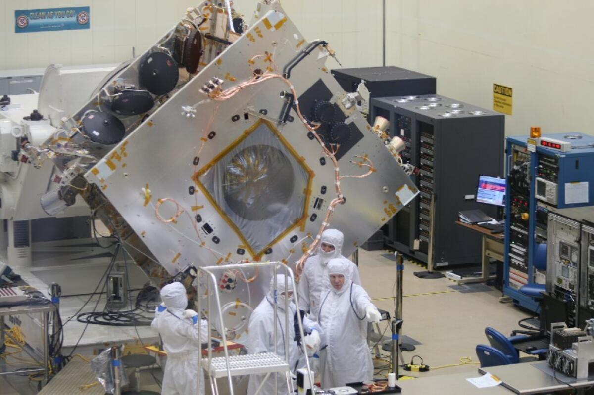 Workers swarm around the MAVEN spacecraft under construction at Lockheed Martin Space Systems south of Denver in December. It's scheduled for a November launch.