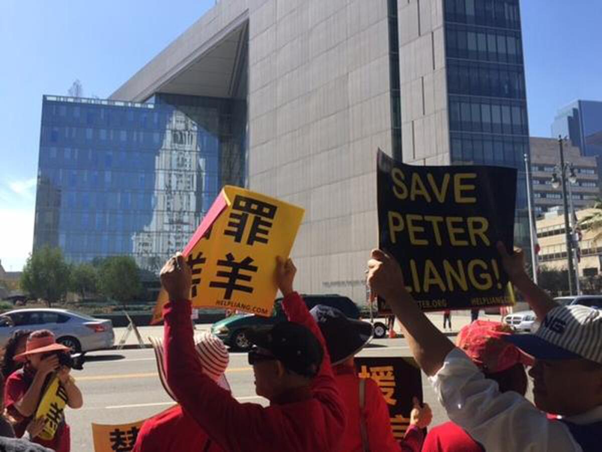 Protesters gather across from Los Angeles Police Department headquarters Saturday to rally in support of Peter Liang, a New York police officer convicted of manslaughter in the deadly 2014 shooting of an unarmed black man.