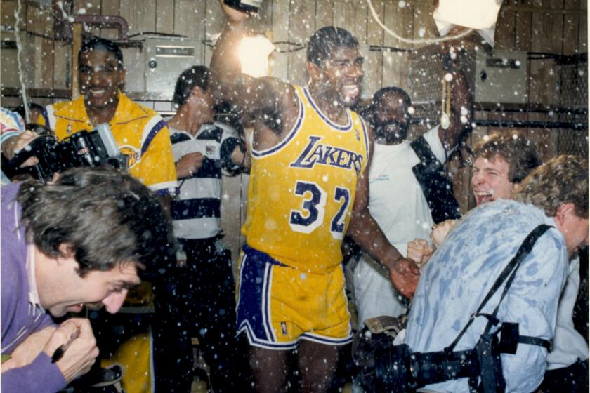 Lakers Magic Johnson celebrates in the locker room in 1987 after defeating the Boston Celtics to win another NBA championship. (For 125 anniversary sports section)