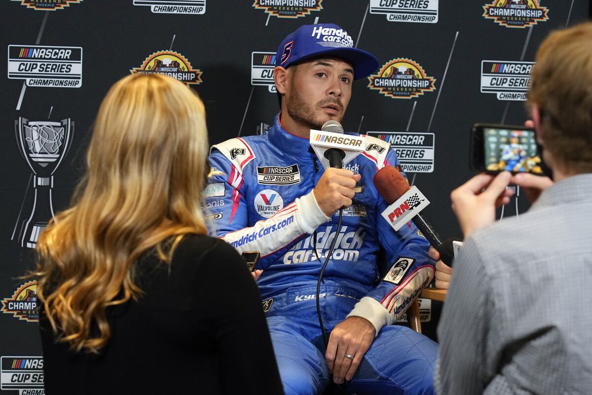 Driver Kyle Larson speaks during media day ahead of Sunday's NASCAR Cup Series championship auto race on Thursday, Nov. 4, 2021, in Phoenix. (AP Photo/Rick Scuteri)