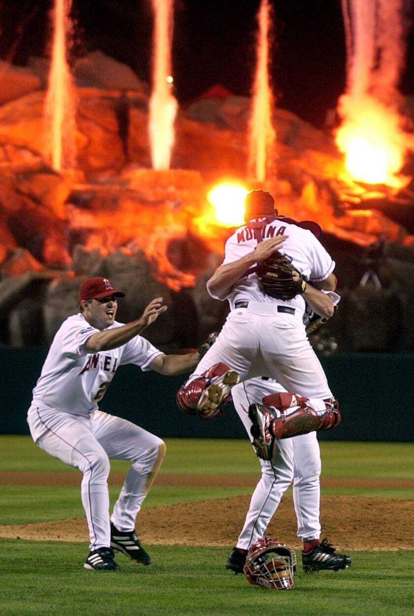 Angels Troy Glaus, Bengie Molina and Troy Percival . celebrate