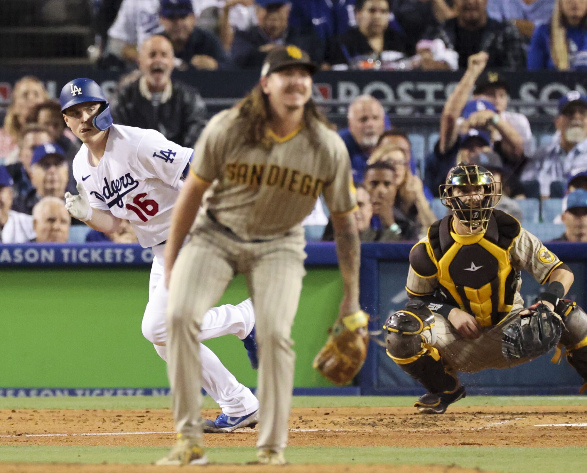 Dodgers' Will Smith runs to first base after hitting a double off Padres pitcher Mike Clevinger.