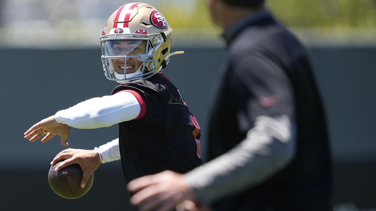 FILE - San Francisco 49ers quarterback Trey Lance hands off to