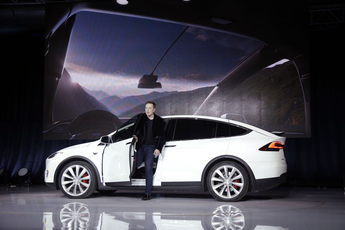 Elon Musk, CEO of Tesla Motors Inc., introduces the Model X car at the company's headquarters Tuesday, Sept. 29, 2015, in Fremont, Calif. (AP Photo/Marcio Jose Sanchez)