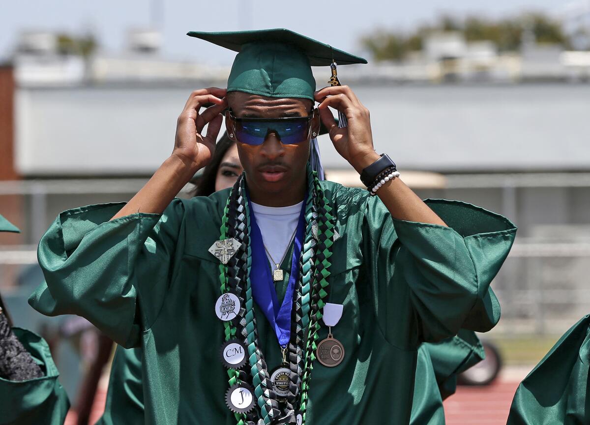Graduate Jammal Campbell prepares to proceed to the graduation ceremony.