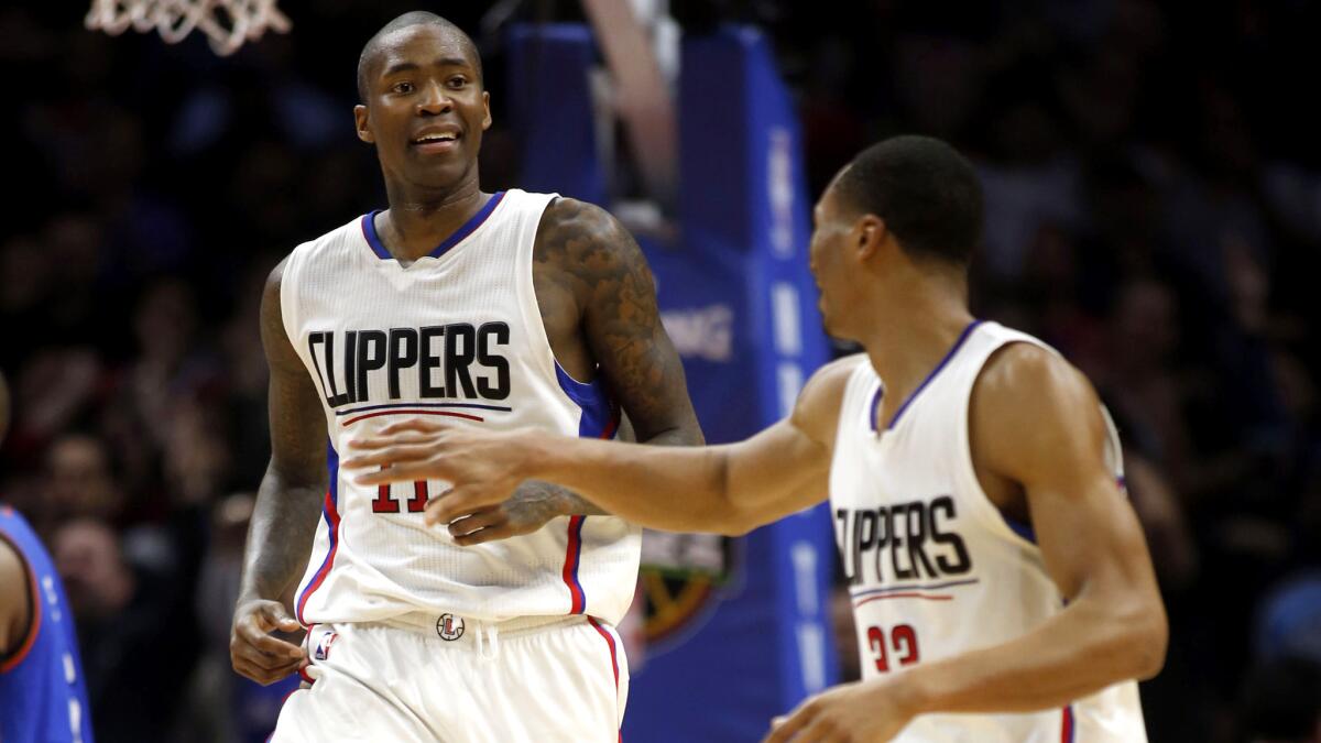 Clippers guard Jamal Crawford does a celebratory leap as he and teammate Wes Johnson celebrate their 103-98 comeback victory over the Thunder.