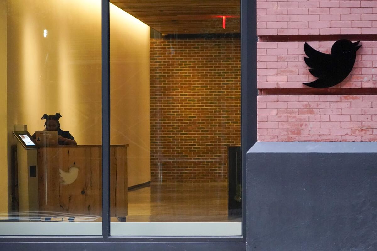 A receptionist works in the lobby of a Twitter office in New York on Oct. 26. 