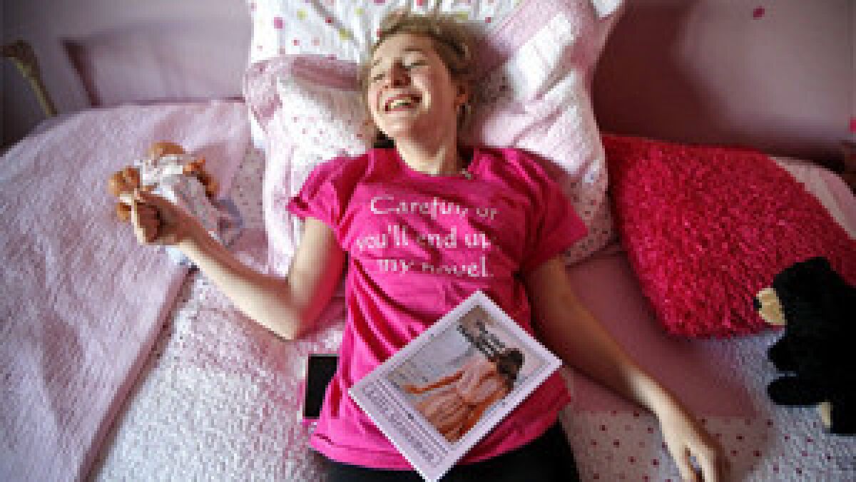 Surrounded with her favorite color, Lilly Grossman, 16 relaxes in her room at home in La Jolla, CA, on Jan 6, 2014. She has written and published a novel " The Girl They Thought They Never Knew", based on her life-long disabilities. She's too weak to stand, sit up, speak clearly and is plagued by nocturnal seizures. A genome scan revealed the answer to her condition, but not a solution to fix two mutated genes.