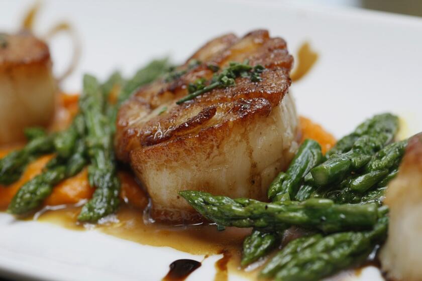 Scallops with heirloom carrot puree, asparagus, and aged balsamic vinegar.