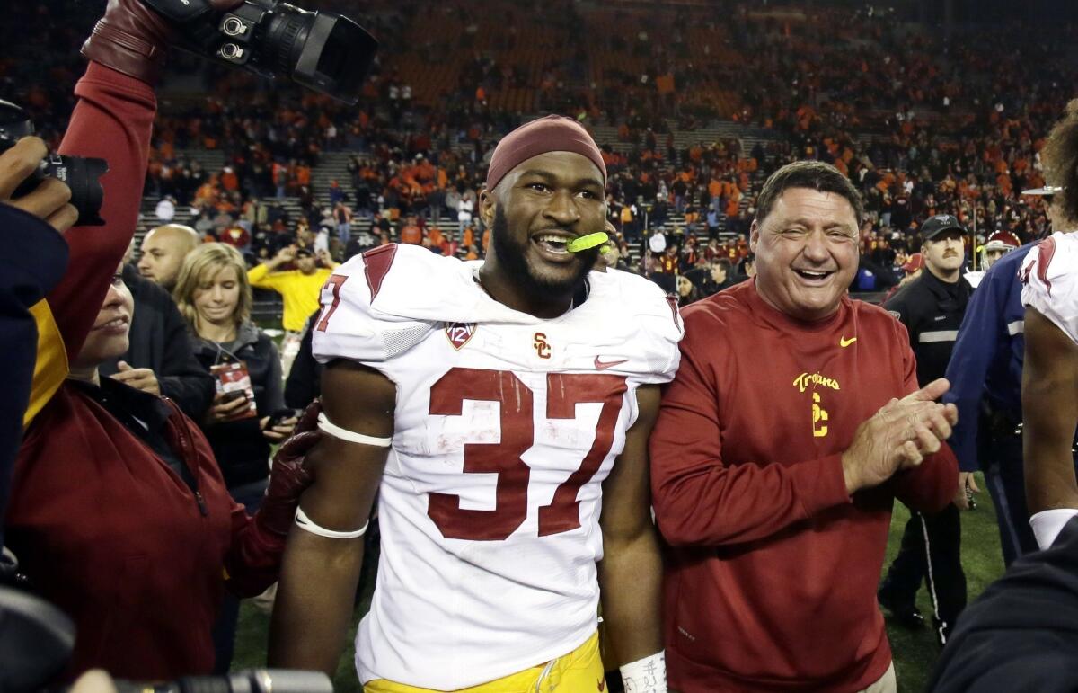 USC Interim Coach Ed Orgeron, right, celebrates with running back Javorius Allen following the Trojans' upset win over Oregon State on Friday. Orgeron says USC is playing with confidence.