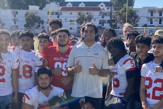 Rams rookie receiver Puka Nacua gives the thumbs among the football team when he visited Hollywood High earlier this season.