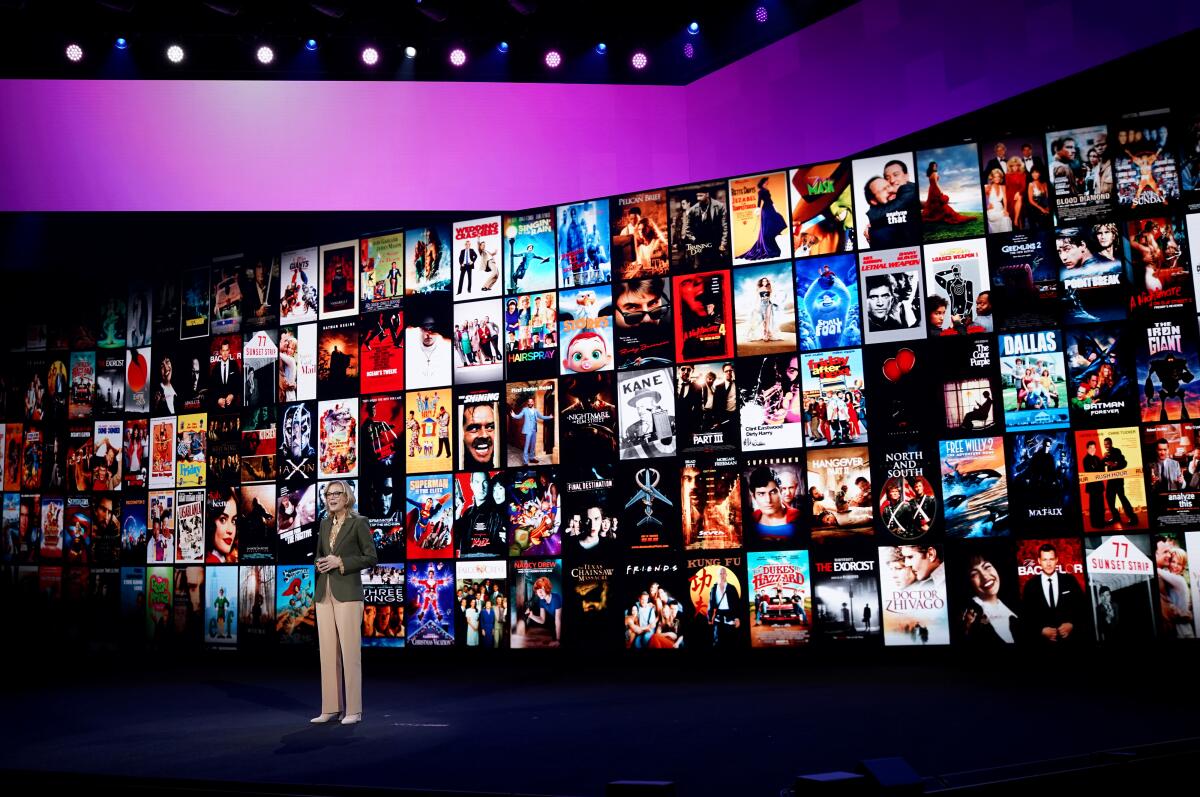 Executive Ann Sarnoff stands in front of a wall displaying HBO Max's various shows