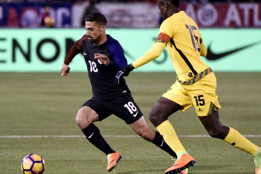 U.S. midfielder Sebastian Lletget advances the ball while under pressure from Jamaica's Je-Vaughn Watson during a game in February.