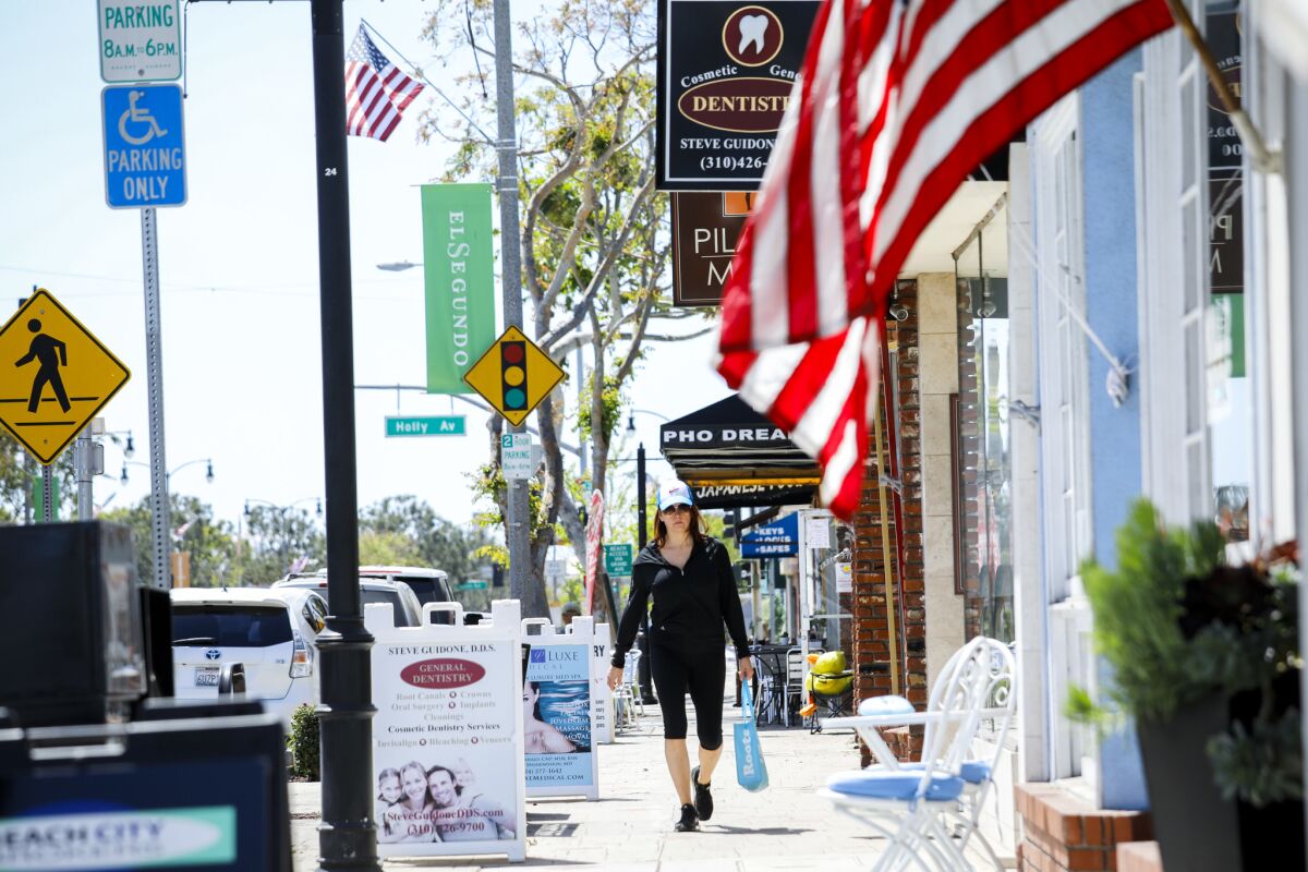Main Street is strewn with American flags in El Segundo, a seaside secret where its "small-town Mayberry kind of thing" is treasured, one resident says.