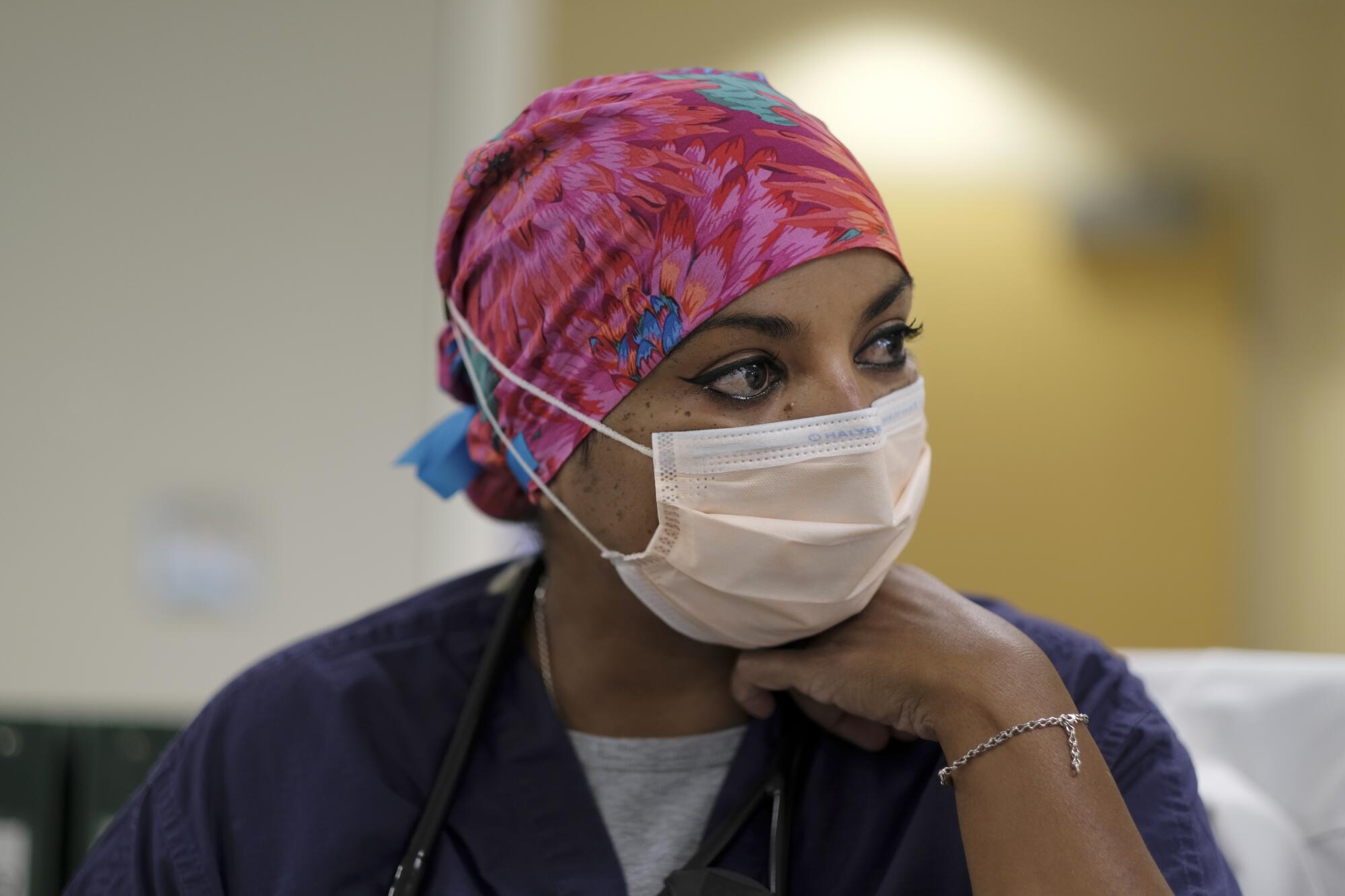 Dr. Anita Sircar wears a mask and scrubs