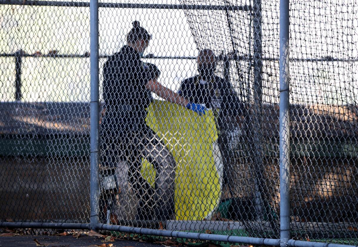 Newport Beach police investigate the scene where a person's body was found at Eastbluff Park in Newport Beach on Saturday.