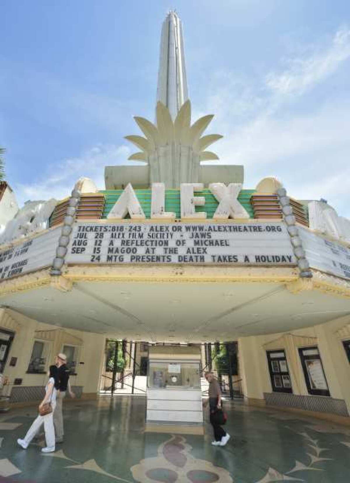 Pedestrians walk past the Alex Theatre. The City Council approved a zone change designating the venue as a civic building.