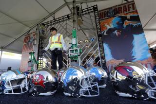 Workers install a helmet display in the Gallery Pavilion on the south lawn of The National WWI Museum and Memorial