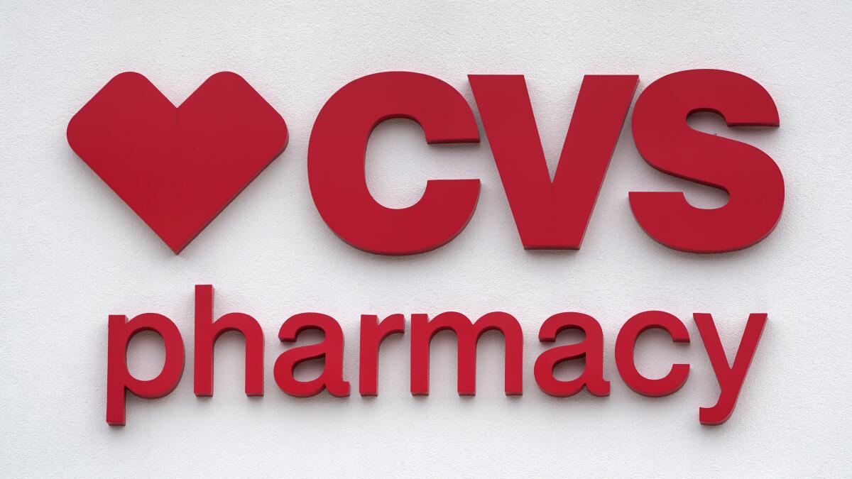 FILE - The CVS Pharmacy logo is displayed on a store on Aug. 3, 2021, in Woburn, Mass. CVS Health will pay about $8 billion to expand into home care, a practice that could cut costs and keep patients happy, provided they get the help they need. (AP Photo/Charles Krupa, File)