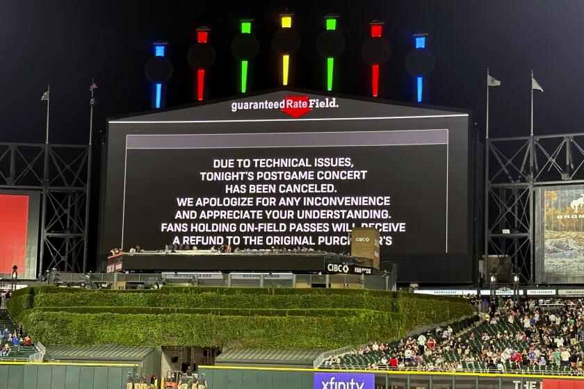 A message on the main scoreboard at Guaranteed Rate Field announces the cancellation.