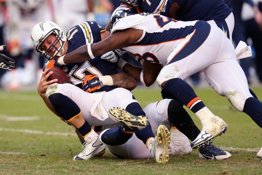 Chargers quarterback Philip Rivers is sacked by linebackers Shane Ray and Shaquil Barrett to end the Chargers' final drive in the fourth quarter.