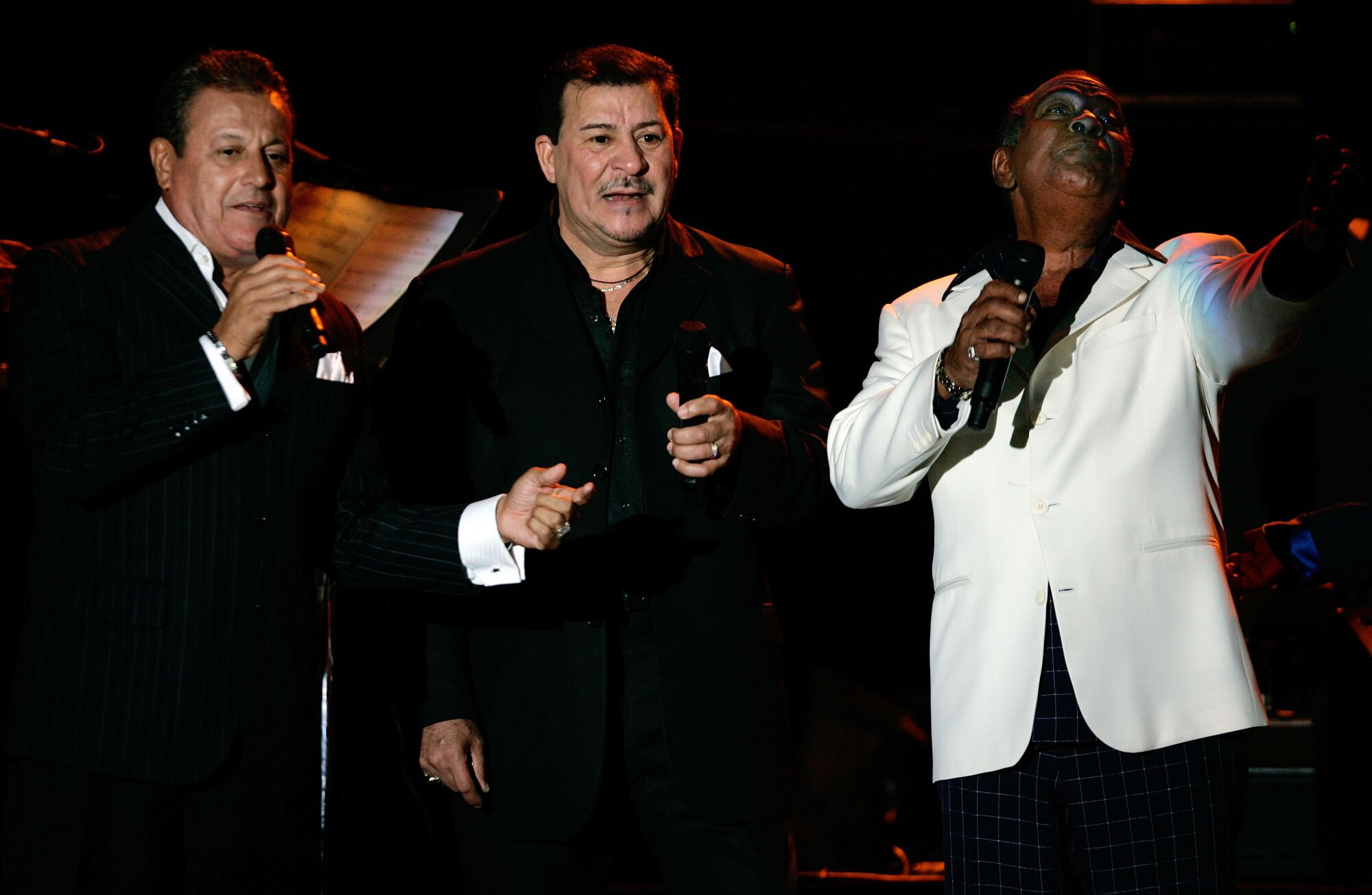 Ismael Miranda, left, Tito Rojas, center, and Cheo Feliciano sing the closing song 