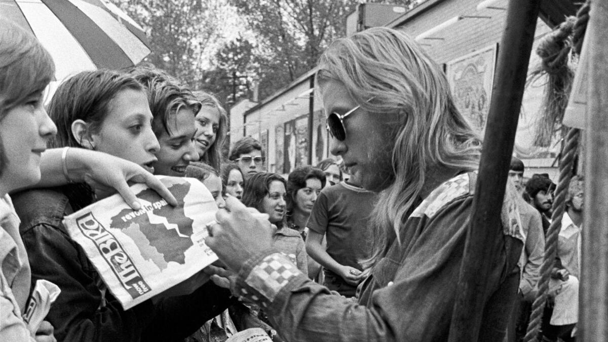 Gregg Allman signs autographs at Peaches Records in Atlanta in 1975. The singer and co-founder of the Allman Brothers Band died Saturday at age 69.