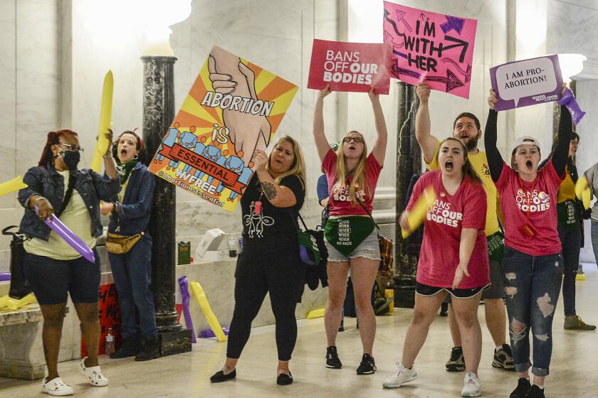 Abortion rights supporters demonstrate outside the Senate chamber at the West Virginia state Capitol on Tuesday, Sept. 13, 2022, in Charleston, W.Va., as lawmakers debated a sweeping bill to ban abortion in the state with few exceptions. (Chris Dorst/Charleston Gazette-Mail via AP)
