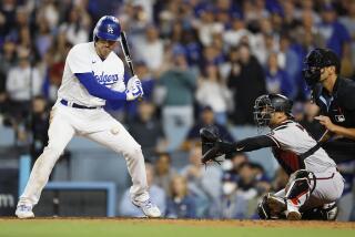 Los Angeles, CA - October 09: Freddie Freeman takes a strike three with runners.