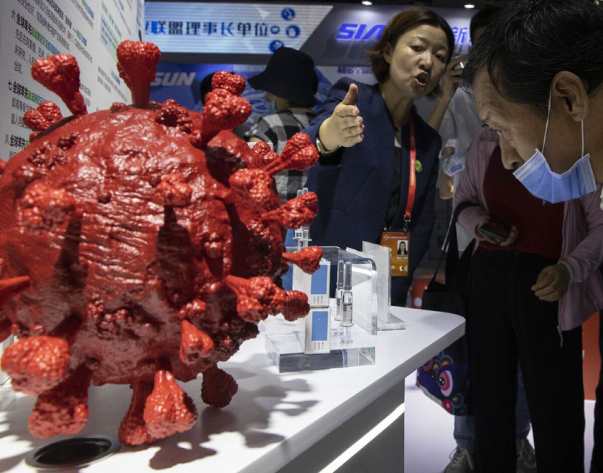 An employee fields questions about a new COVID-19 vaccine during a trade fair in Beijing last week.