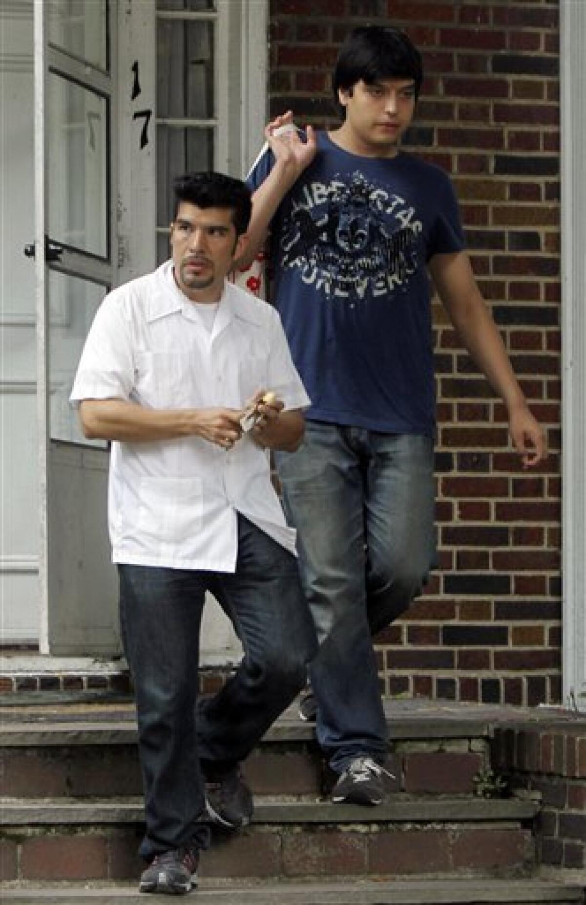 Waldo Mariscal, left, and his half-brother Juan Lazaro Jr., sons of accused spy Vicky Pelaez, leave their home in Yonkers, N.Y., Friday, July 9, 2010. Lazaro Jr., 17, is a gifted pianist who has lived his whole life in the U.S., although he has spent considerable time in Peru, where his mother was born. Mariscal is an architect. (AP Photo/Seth Wenig)