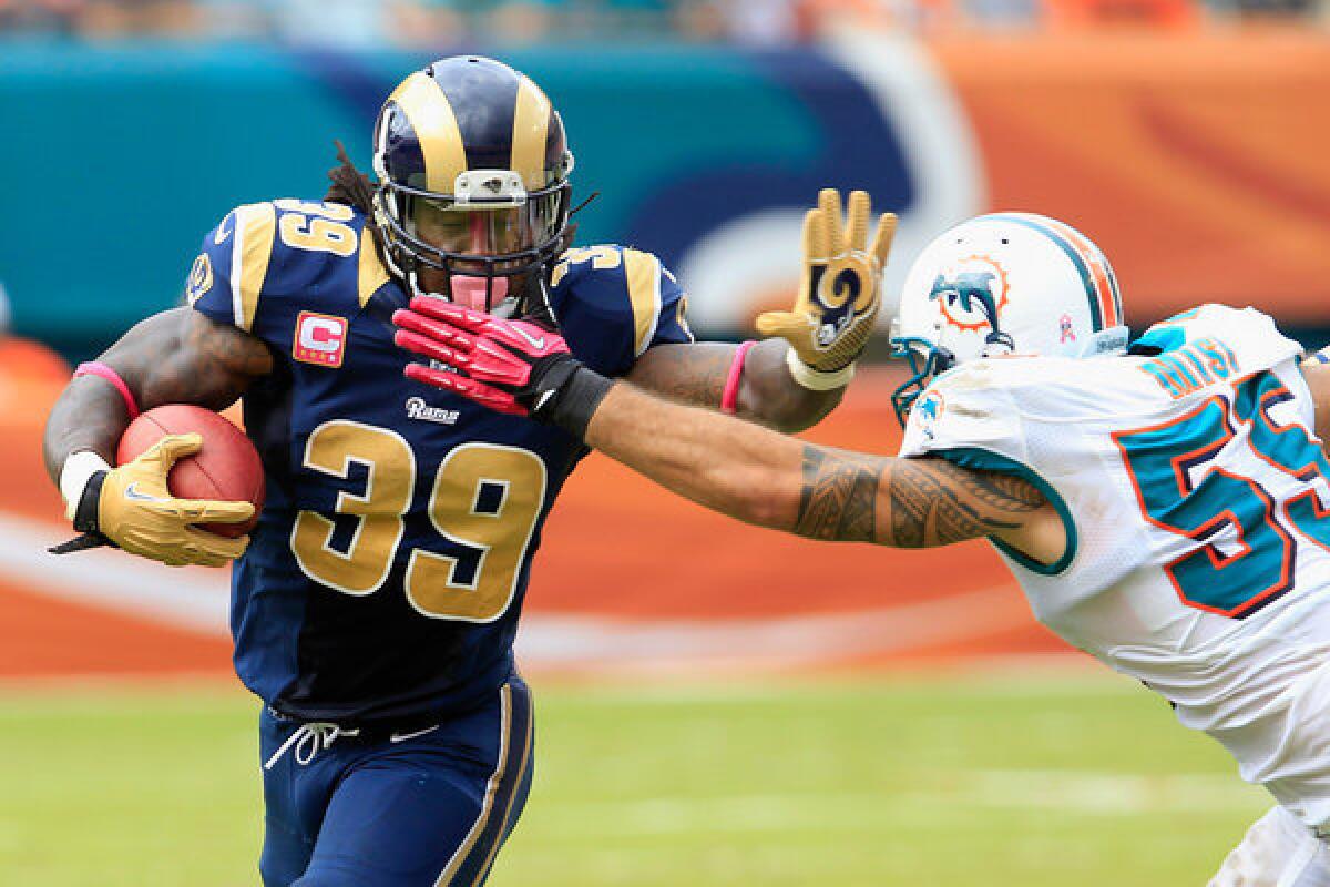 Rams running back Steven Jackson tries to get past Dolphins linebacker Koa Misi during a game last season in Miami.