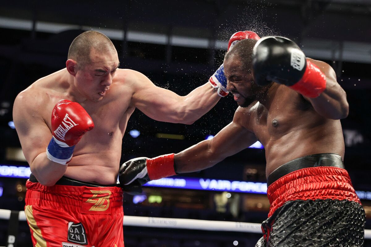 Zhilei Zhang and Jerry Forrest trade punches during their heavyweight bout.